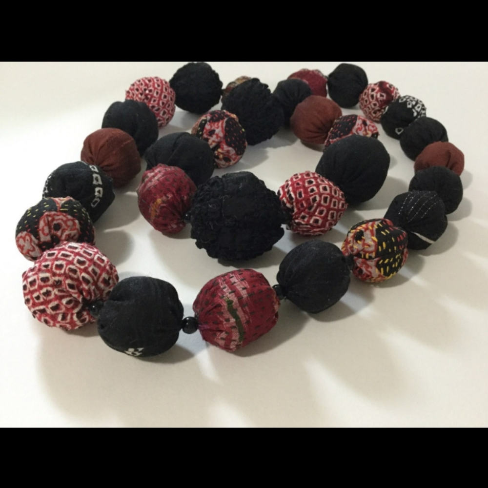 Fabric covered bead necklace.